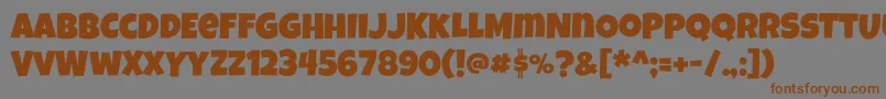 フォントLuckiestguy – 茶色の文字が灰色の背景にあります。