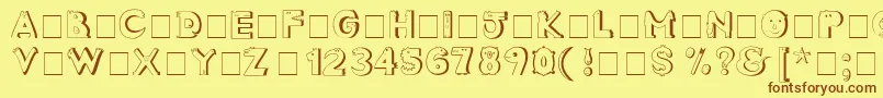 フォントCrazyCreaturesNormal – 茶色の文字が黄色の背景にあります。