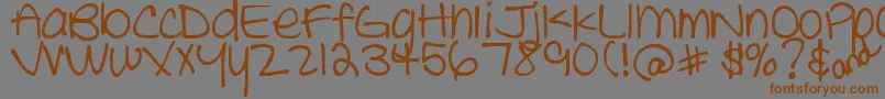 フォントDjbTheCheerleader – 茶色の文字が灰色の背景にあります。