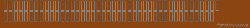 Flyman-fontti – harmaat kirjasimet ruskealla taustalla