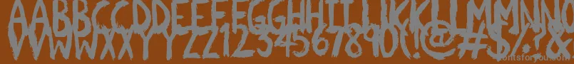 Scratchies-fontti – harmaat kirjasimet ruskealla taustalla