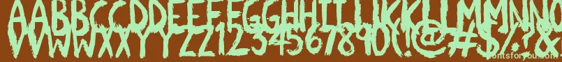 フォントScratchies – 緑色の文字が茶色の背景にあります。