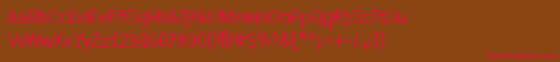 フォントEveryLittleThingThatYouDoOrSay – 赤い文字が茶色の背景にあります。