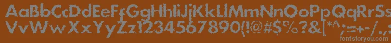 Dsstainc-fontti – harmaat kirjasimet ruskealla taustalla