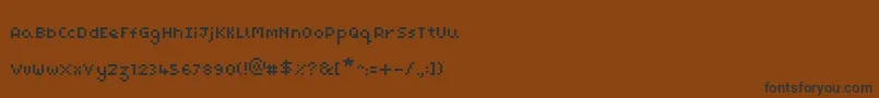 フォントPixelMaz – 黒い文字が茶色の背景にあります
