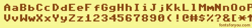 フォントCommodore64Pixeled – 茶色の文字が黄色の背景にあります。