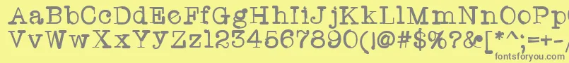 フォントTwriterone – 黄色の背景に灰色の文字