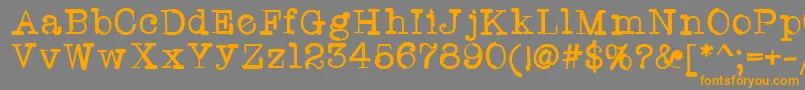 フォントTwriterone – オレンジの文字は灰色の背景にあります。