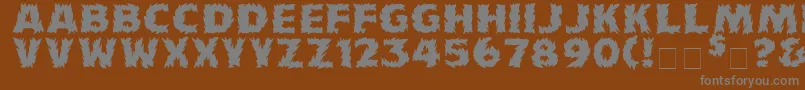 Firecatmedium-fontti – harmaat kirjasimet ruskealla taustalla