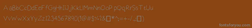 Praktiscript Font – Gray Fonts on Brown Background