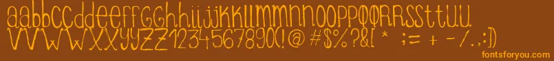 フォントItziargobigRegular – オレンジ色の文字が茶色の背景にあります。