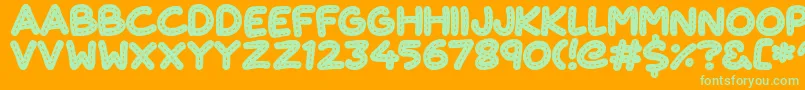 CuteStitch-Schriftart – Grüne Schriften auf orangefarbenem Hintergrund