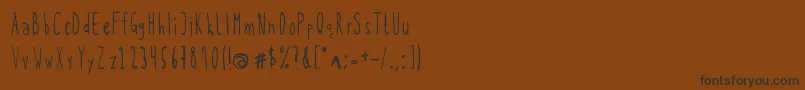 フォントKohicle25 – 黒い文字が茶色の背景にあります