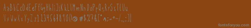 フォントKohicle25 – 茶色の背景に灰色の文字