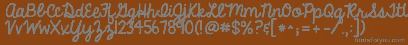 Kgalwaysagoodtime-fontti – harmaat kirjasimet ruskealla taustalla