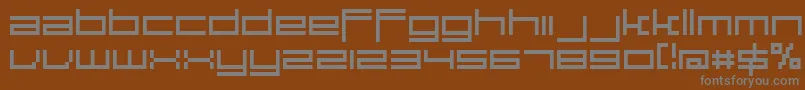 Fonte Large9Normal – fontes cinzas em um fundo marrom