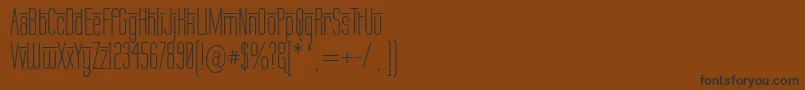 フォントLabtopOverscore – 黒い文字が茶色の背景にあります