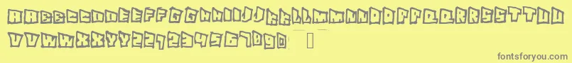 Superslant-fontti – harmaat kirjasimet keltaisella taustalla