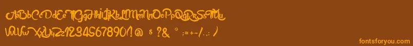 フォントAnabelleScriptLight – オレンジ色の文字が茶色の背景にあります。