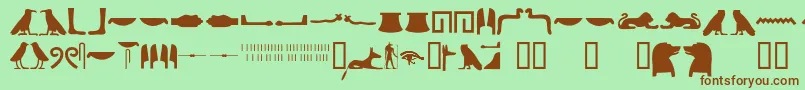 Fonte Egyptianhieroglyphssilhouet – fontes marrons em um fundo verde