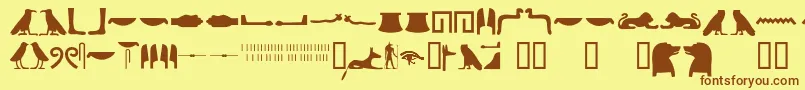 Egyptianhieroglyphssilhouet-fontti – ruskeat fontit keltaisella taustalla