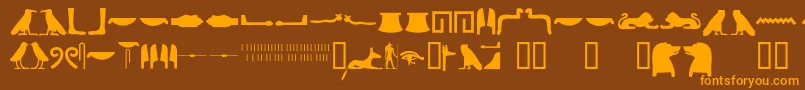 Egyptianhieroglyphssilhouet-fontti – oranssit fontit ruskealla taustalla