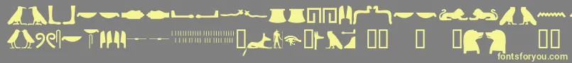 Egyptianhieroglyphssilhouet-fontti – keltaiset fontit harmaalla taustalla