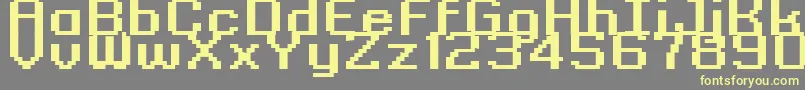Czcionka GrixelKyrou9RegularBoldXtnd – żółte czcionki na szarym tle
