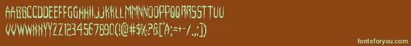 フォントHorroroidcond – 緑色の文字が茶色の背景にあります。