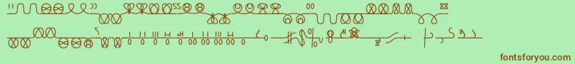 Numukki-Schriftart – Braune Schriften auf grünem Hintergrund
