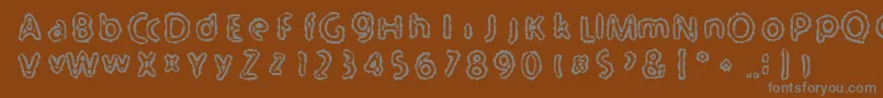 Serated-Schriftart – Graue Schriften auf braunem Hintergrund
