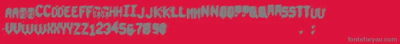 UnderTheBed-fontti – harmaat kirjasimet punaisella taustalla