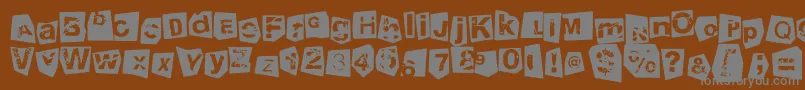 TengoATusHijosNegativo-Schriftart – Graue Schriften auf braunem Hintergrund