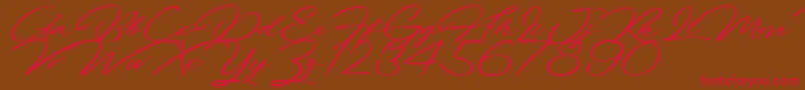 フォントFortunatesDecember – 赤い文字が茶色の背景にあります。