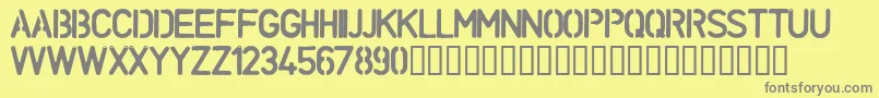 UnconformRound-fontti – harmaat kirjasimet keltaisella taustalla