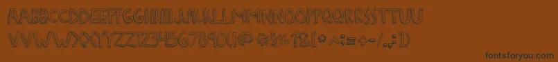 Czcionka DenneFreakshow – czarne czcionki na brązowym tle