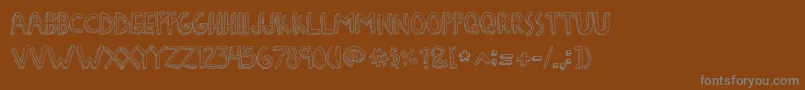 Шрифт DenneFreakshow – серые шрифты на коричневом фоне