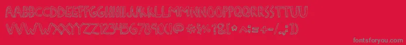 DenneFreakshow-Schriftart – Graue Schriften auf rotem Hintergrund