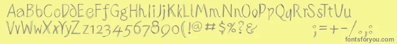 フォントSketchedalphabet – 黄色の背景に灰色の文字