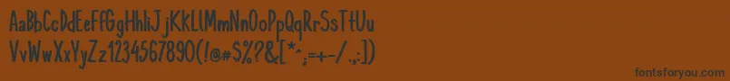 フォントKomixconBold – 黒い文字が茶色の背景にあります