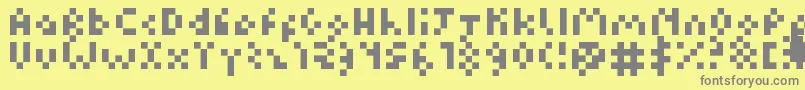 フォントKuadriculado7luas – 黄色の背景に灰色の文字