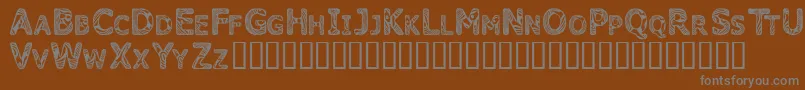 Candk-Schriftart – Graue Schriften auf braunem Hintergrund