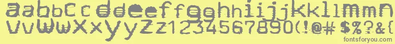 Stock-fontti – harmaat kirjasimet keltaisella taustalla