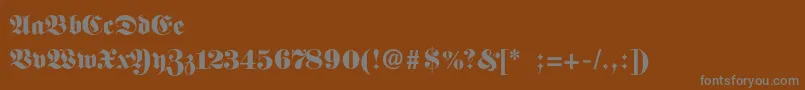 Fittipauldi-fontti – harmaat kirjasimet ruskealla taustalla
