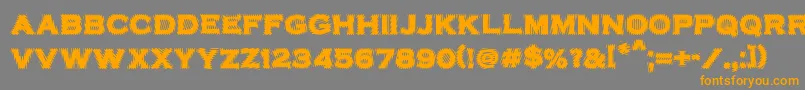 VtcbadplatingRegular-Schriftart – Orangefarbene Schriften auf grauem Hintergrund