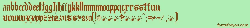 Artofilluminating-fontti – ruskeat fontit vihreällä taustalla