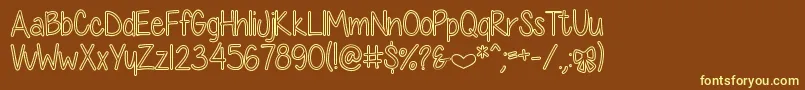 DiamondGirlHollow-fontti – keltaiset fontit ruskealla taustalla
