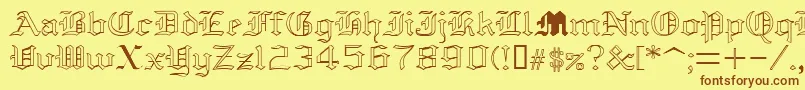 フォントYolda – 茶色の文字が黄色の背景にあります。