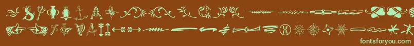 フォントTypeembellishmentsthree – 緑色の文字が茶色の背景にあります。