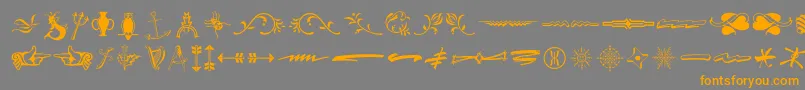 フォントTypeembellishmentsthree – オレンジの文字は灰色の背景にあります。